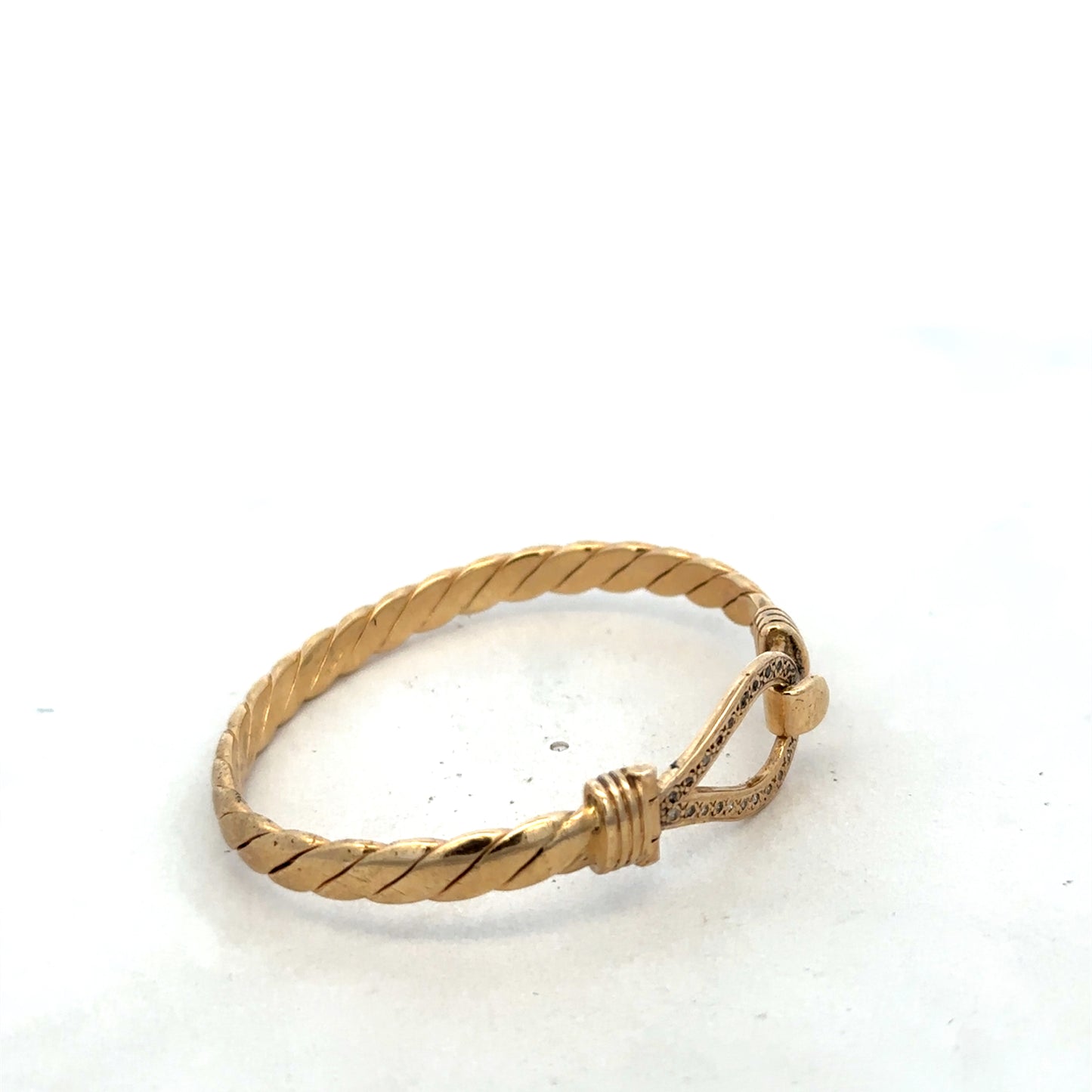 9ct yellow gold bangle bracelet weighing 12.7g by Reeves and Sons, with a smooth polished finish and slender design.
