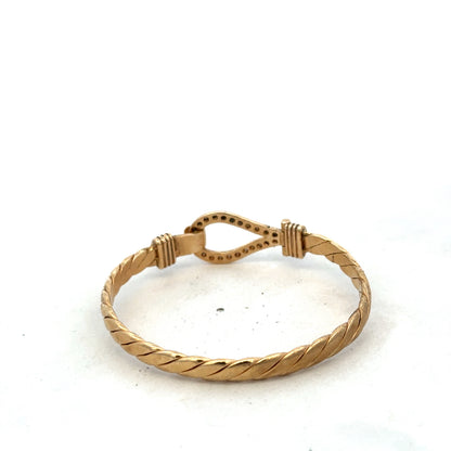 9ct yellow gold bracelet by Reeves and Sons, featuring a sleek, shiny bangle design with a polished finish.