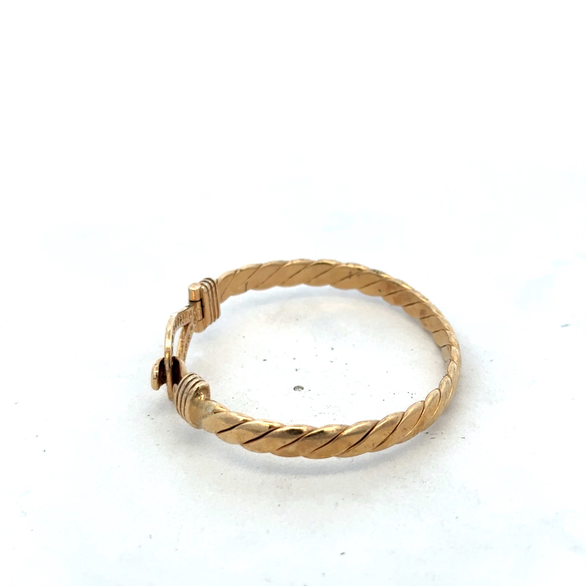 9ct yellow gold bracelet by Reeves and Sons, stylish bangle weighing 12.7g, with a smooth polished finish.