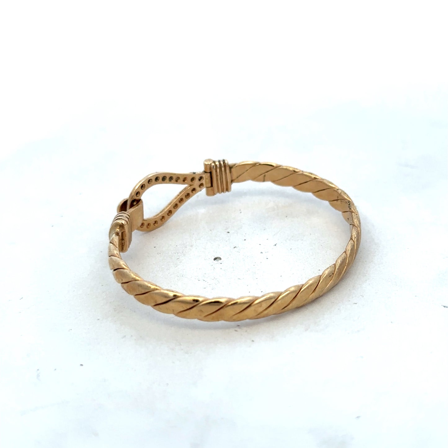 9ct yellow gold bracelet by Reeves and Sons, featuring a sleek bangle design with a polished finish and 12.7g weight.