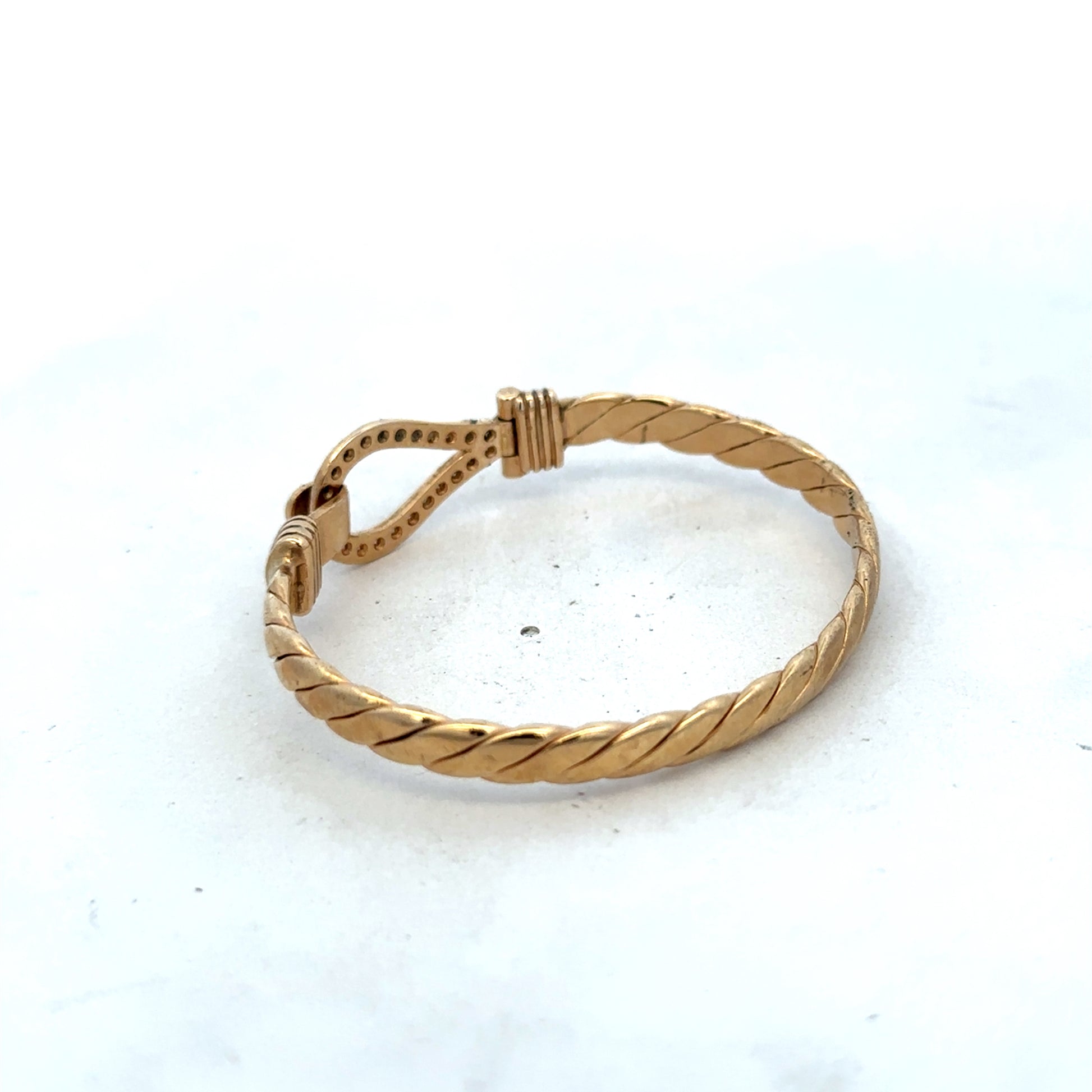 9ct yellow gold bracelet by Reeves and Sons, featuring a sleek bangle design with a polished finish and 12.7g weight.