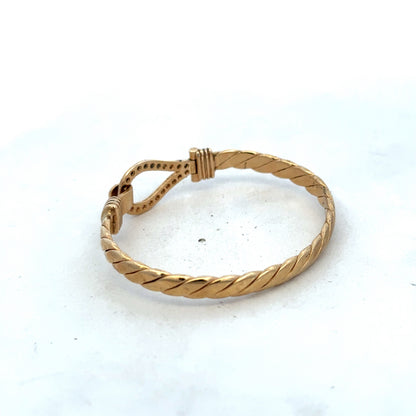 9ct yellow gold bracelet by Reeves and Sons, featuring a sleek bangle design with a polished finish and 12.7g weight.