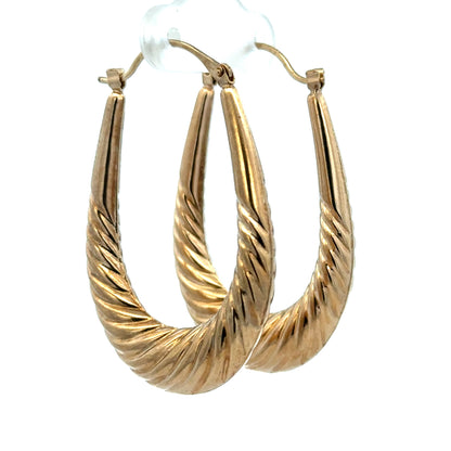 9ct yellow gold hoop earrings weighing 3.4g, featuring a classic round design, from Reeves and Sons.