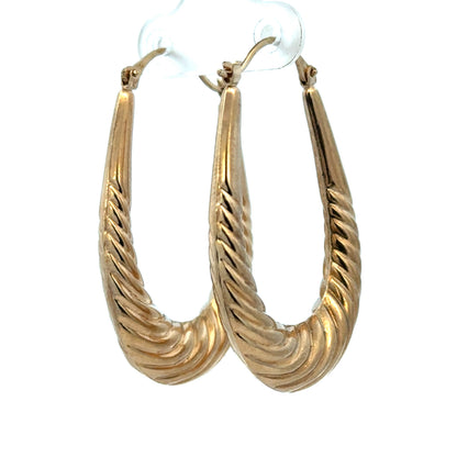 9ct yellow gold hoop earrings weighing 3.4g, shown with a close-up of the shiny, circular design by Reeves and Sons.