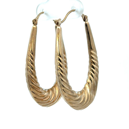 Reeves and Sons 9ct yellow gold hoop earrings, lightweight 3.4g, with a classic circular design, shown in close-up.