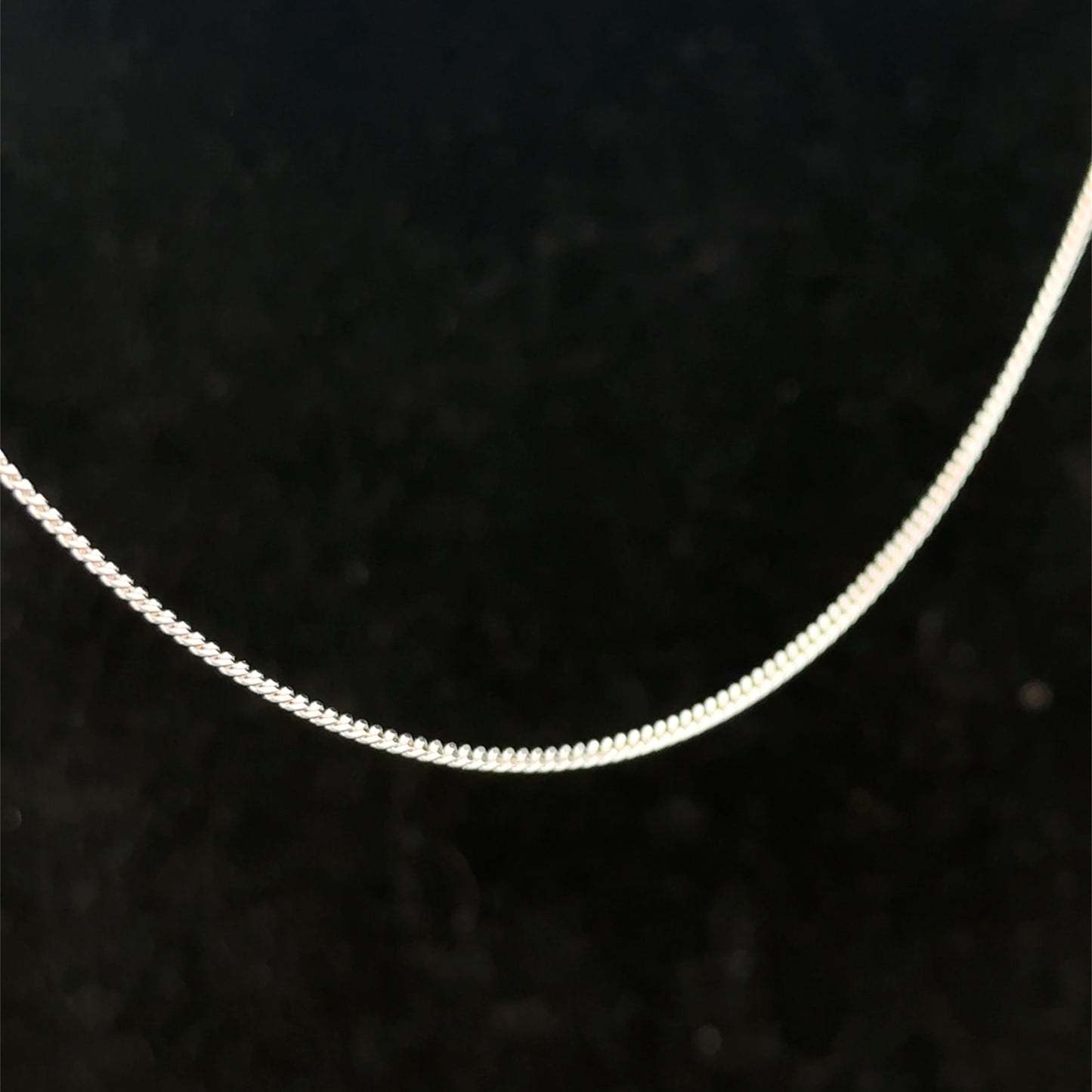 Reeves and Sons 9ct white gold chain weighing 2.9g, featuring a delicate link design, shown in close-up.