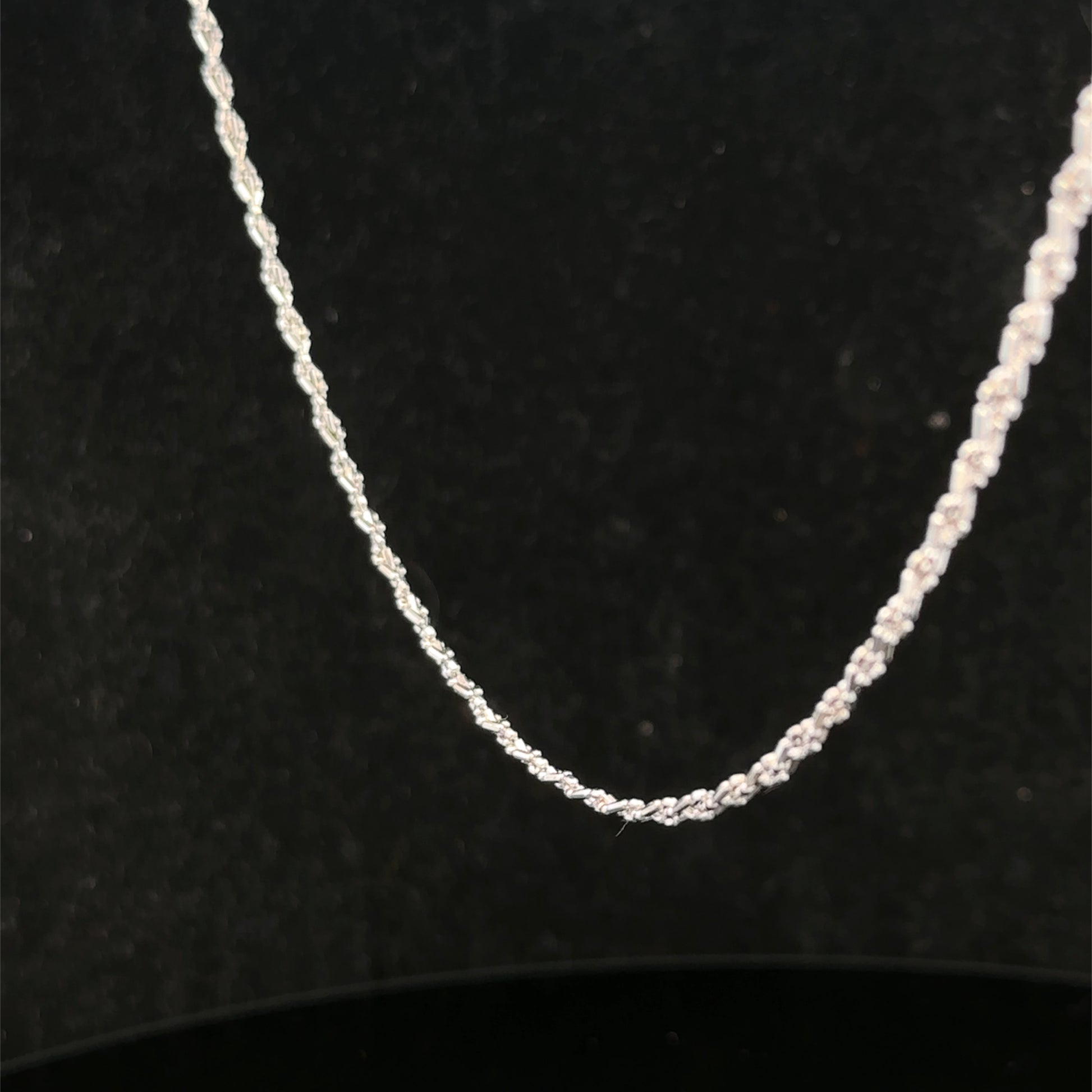 Reeves and Sons 9ct white gold chain weighing 3.2g, featuring a delicate link design, shown in a close-up image.
