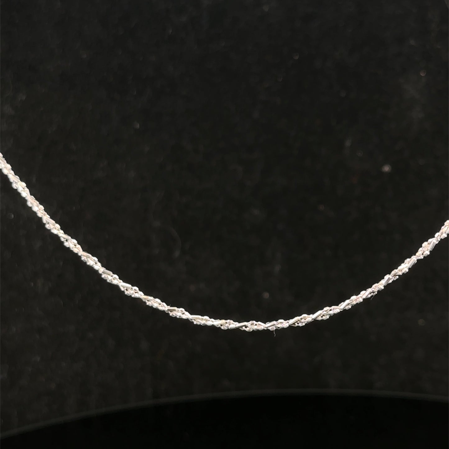 9ct white gold chain weighing 3.2g, sleek and elegant Reeves and Sons jewelry, displayed on a plain background.