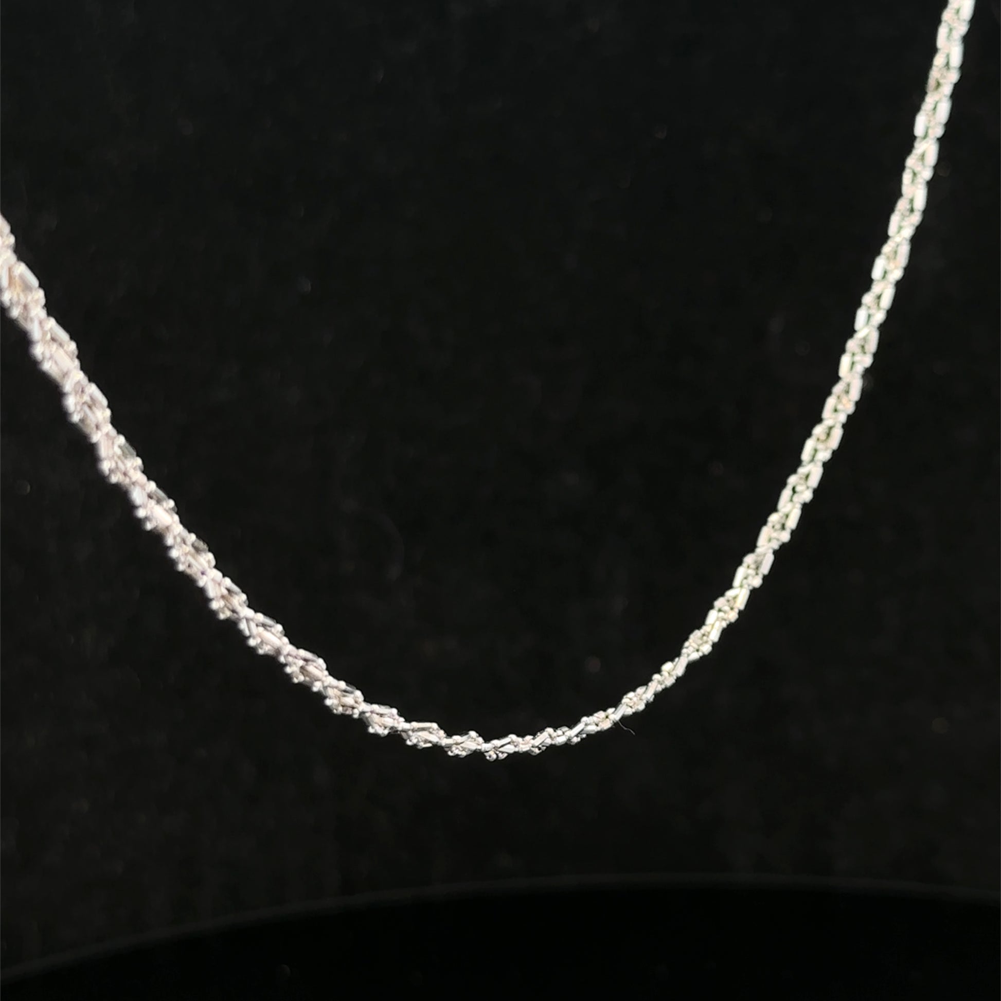 9ct white gold chain weighing 3.2g, from Reeves and Sons, shown in a close-up image highlighting its fine craftsmanship.