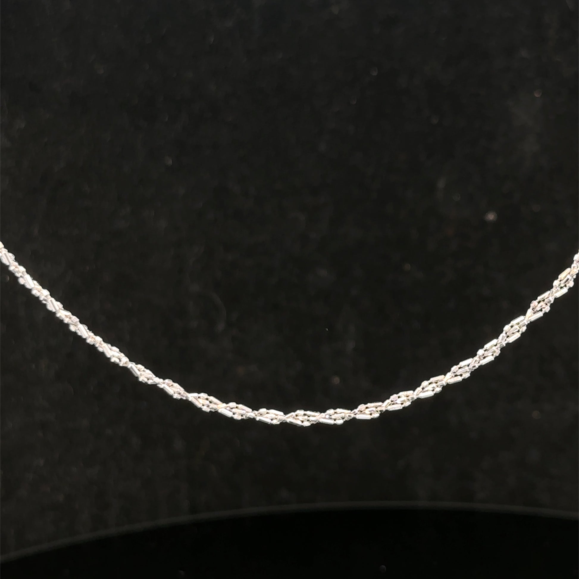 9ct white gold chain weighing 3.2g, featuring a delicate link design from Reeves and Sons, shown in the image.