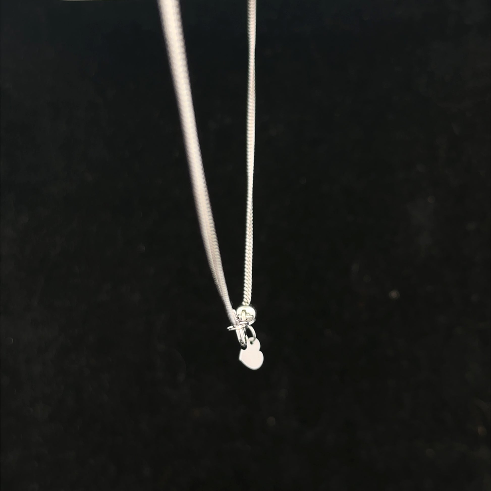 9ct white gold chain weighing 2.7g, from Reeves and Sons, showcasing a delicate, polished chain with detailed links.