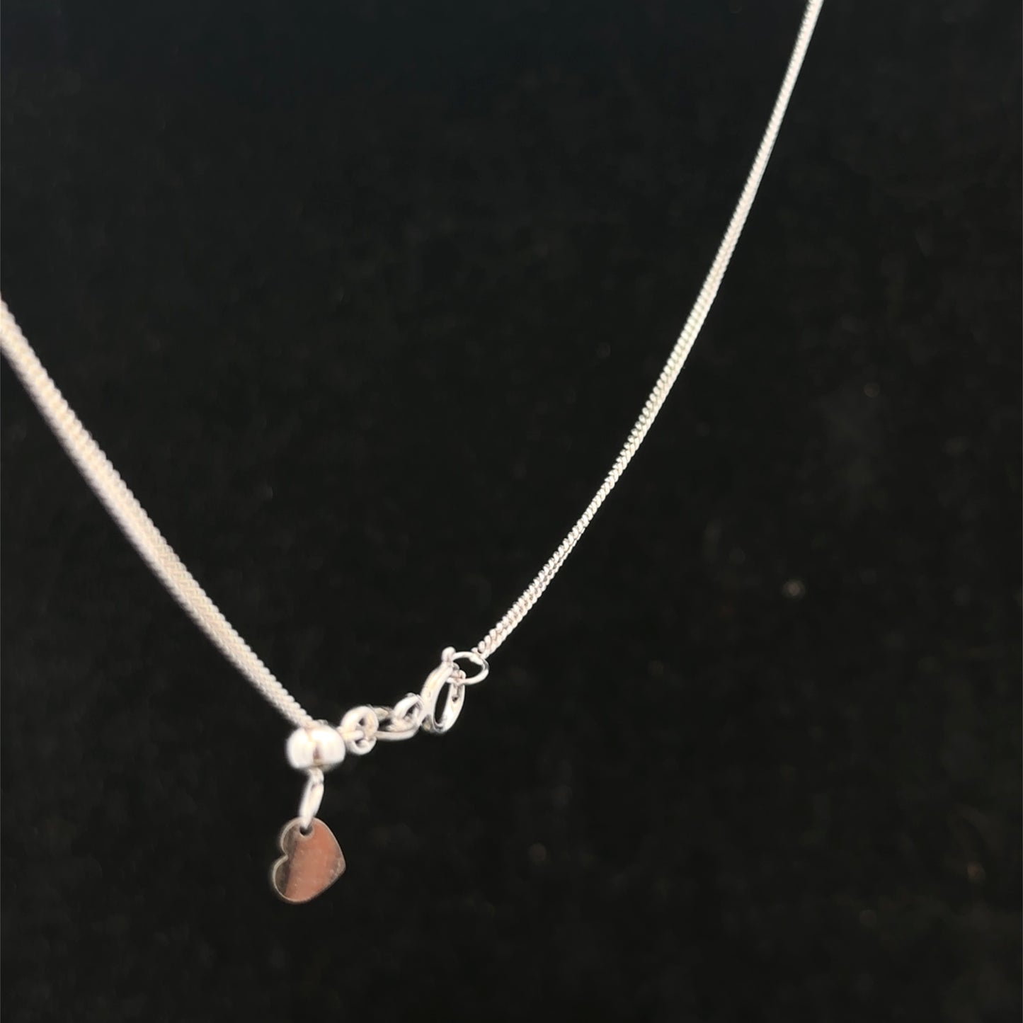 9ct white gold chain weighing 2.7g, displayed on a plain background, showcasing its elegant link design from Reeves and Sons.