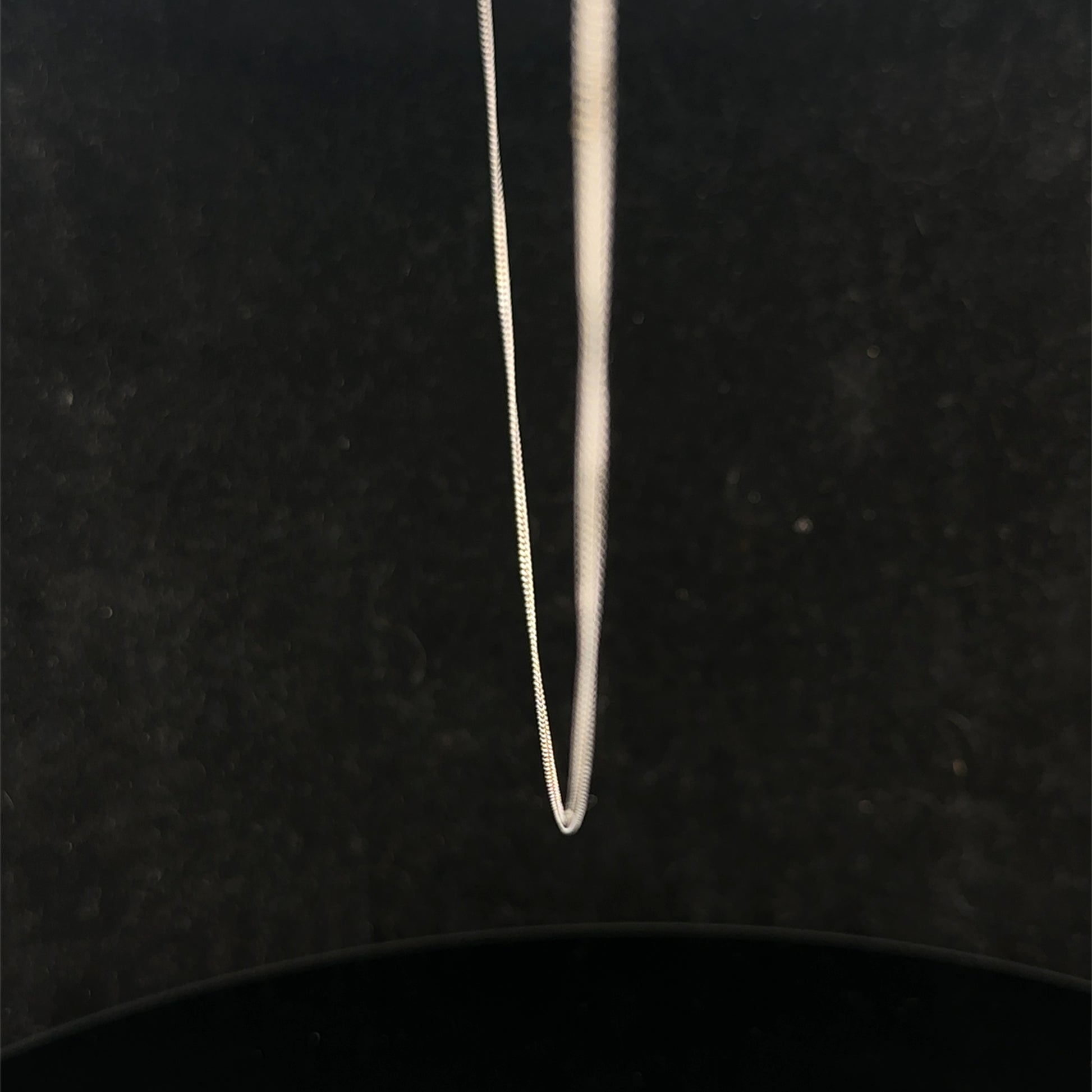 9ct white gold chain weighing 1.5g featuring a delicate link design, crafted by Reeves and Sons.