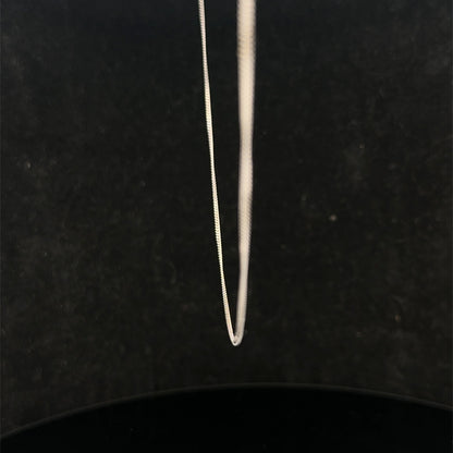 9ct white gold chain weighing 1.5g featuring a delicate link design, crafted by Reeves and Sons.