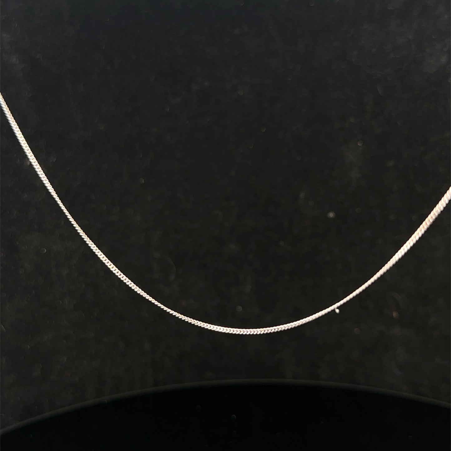 9ct white gold chain weighing 1.5g with a delicate link design, crafted by Reeves and Sons.