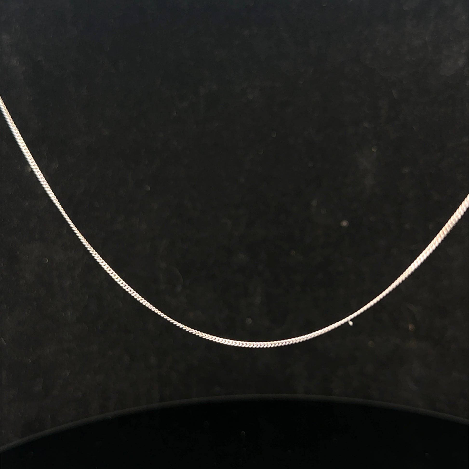 9ct white gold chain weighing 1.5g with a delicate link design, crafted by Reeves and Sons.