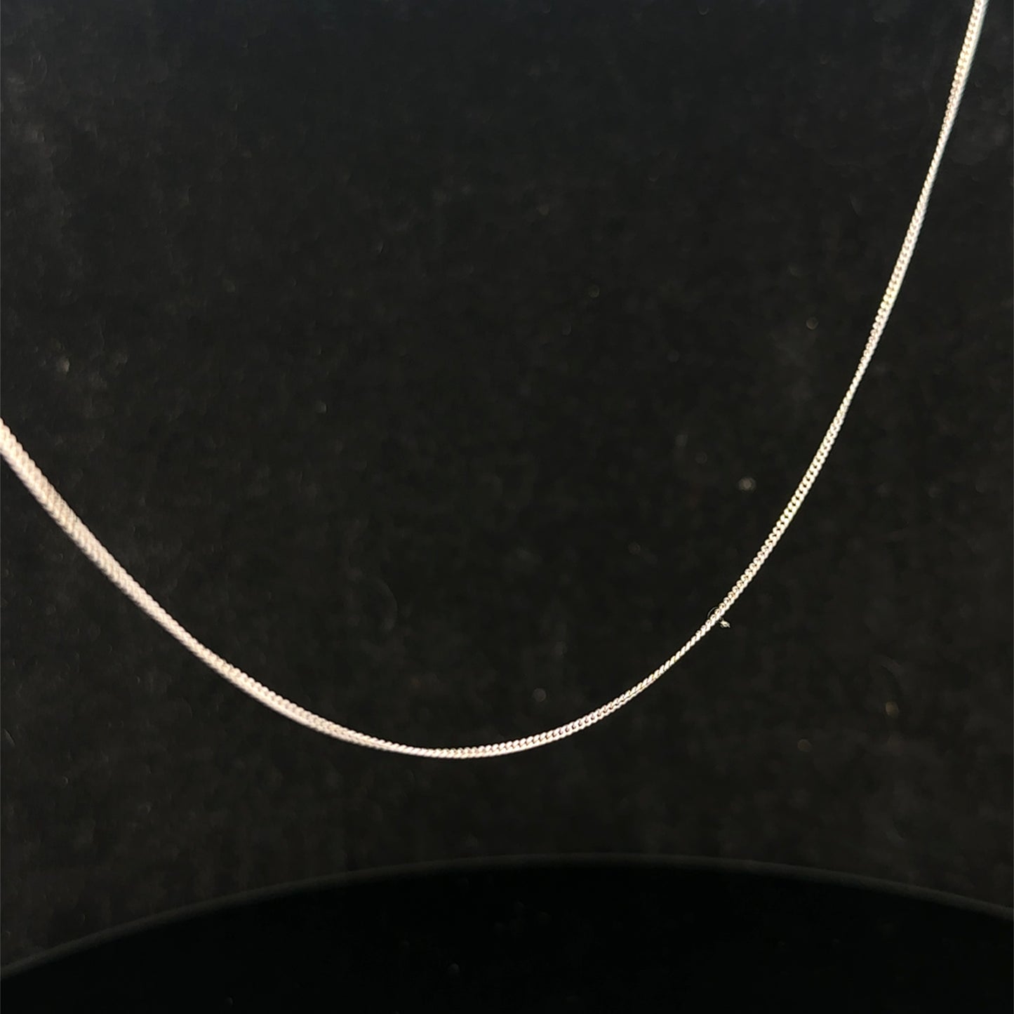 9ct white gold chain weighing 1.5g by Reeves and Sons, close-up view showing fine craftsmanship and polished finish