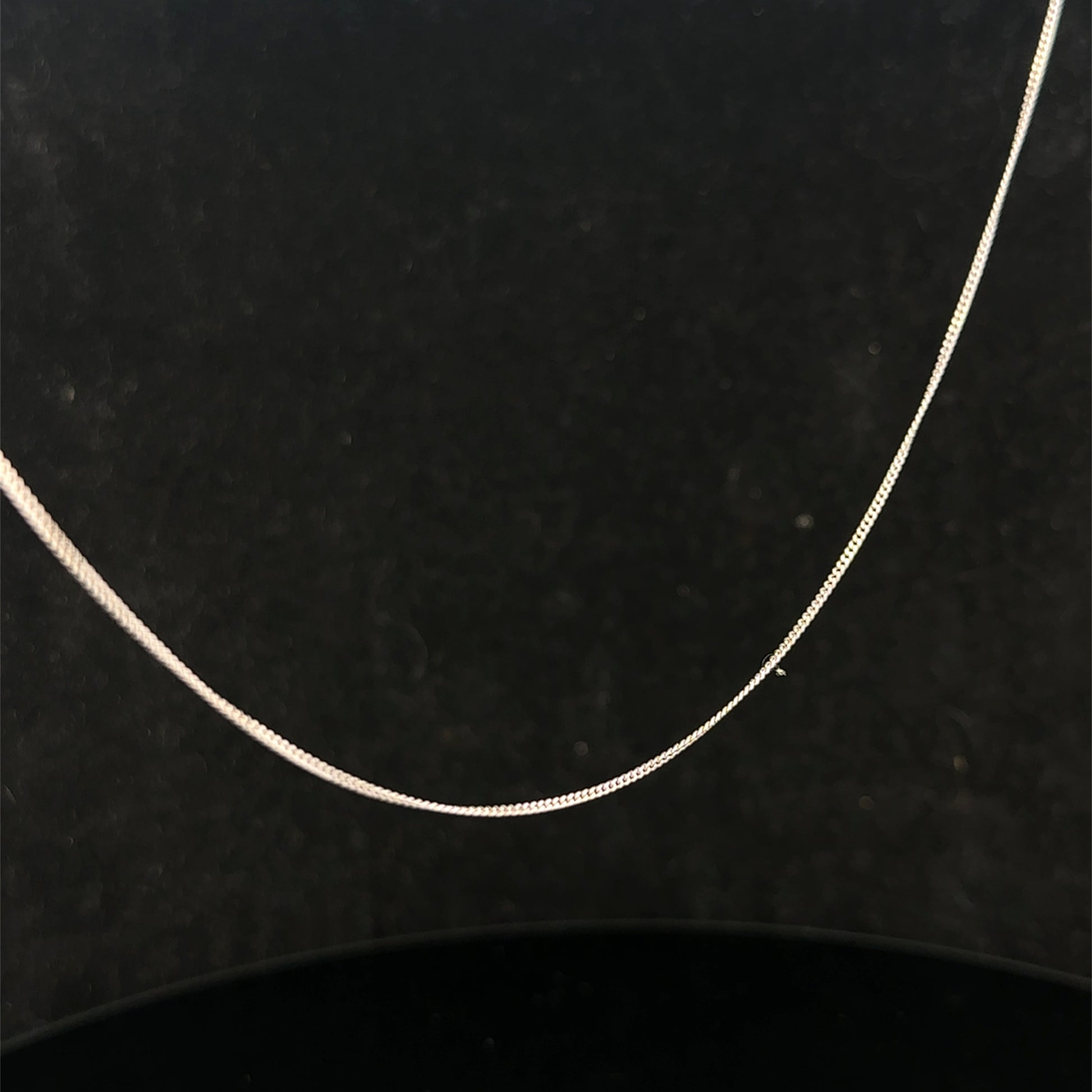 9ct white gold chain weighing 1.5g by Reeves and Sons, close-up view showing fine craftsmanship and polished finish
