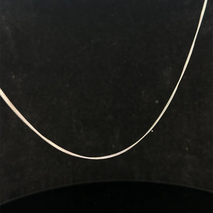 9ct white gold chain weighing 1.5g by Reeves and Sons, close-up view showing fine craftsmanship and polished finish