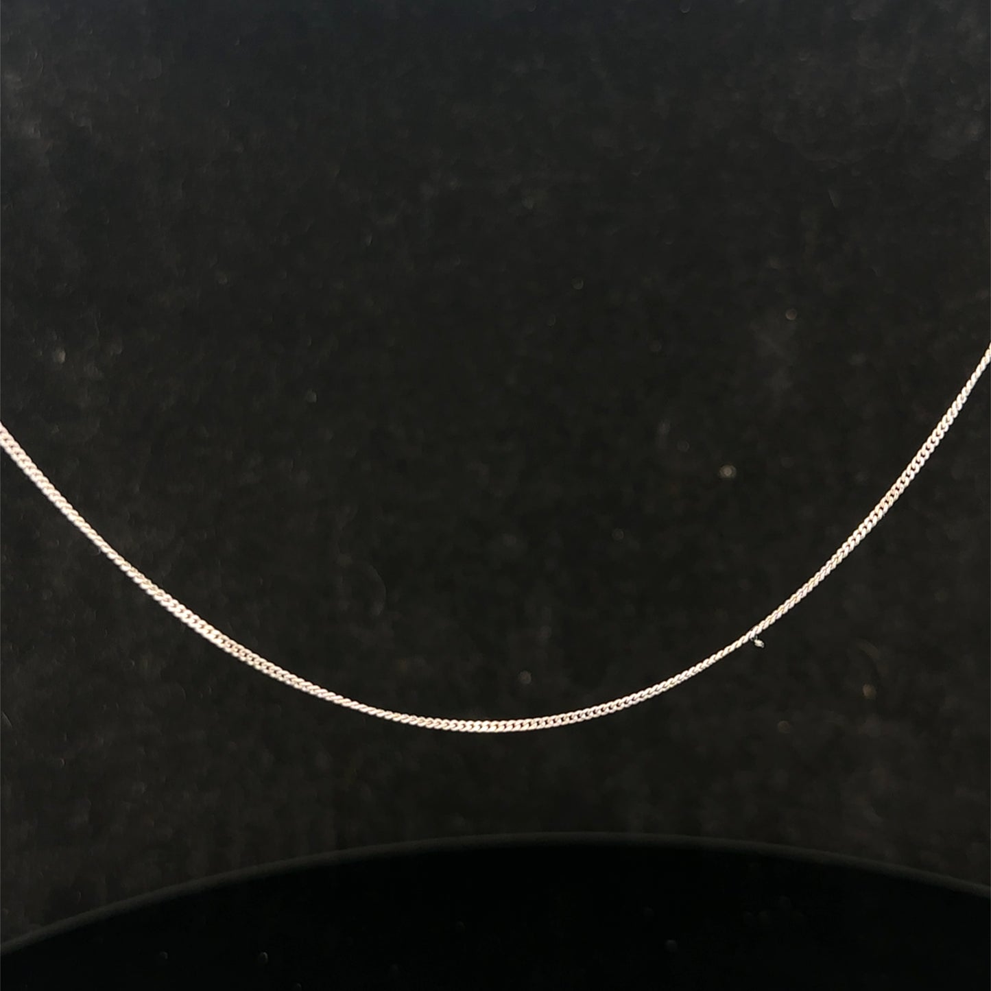 9ct white gold chain weighing 1.5g, featuring a delicate link design, by Reeves and Sons, shown in the product image.