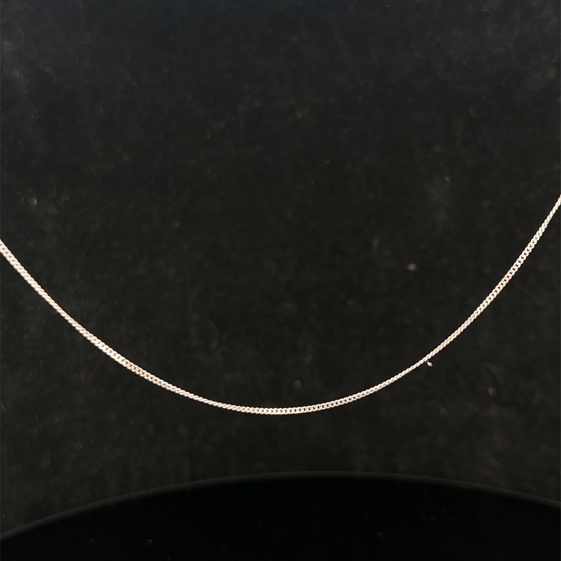 9ct white gold chain weighing 1.5g, featuring a delicate link design, by Reeves and Sons, shown in the product image.