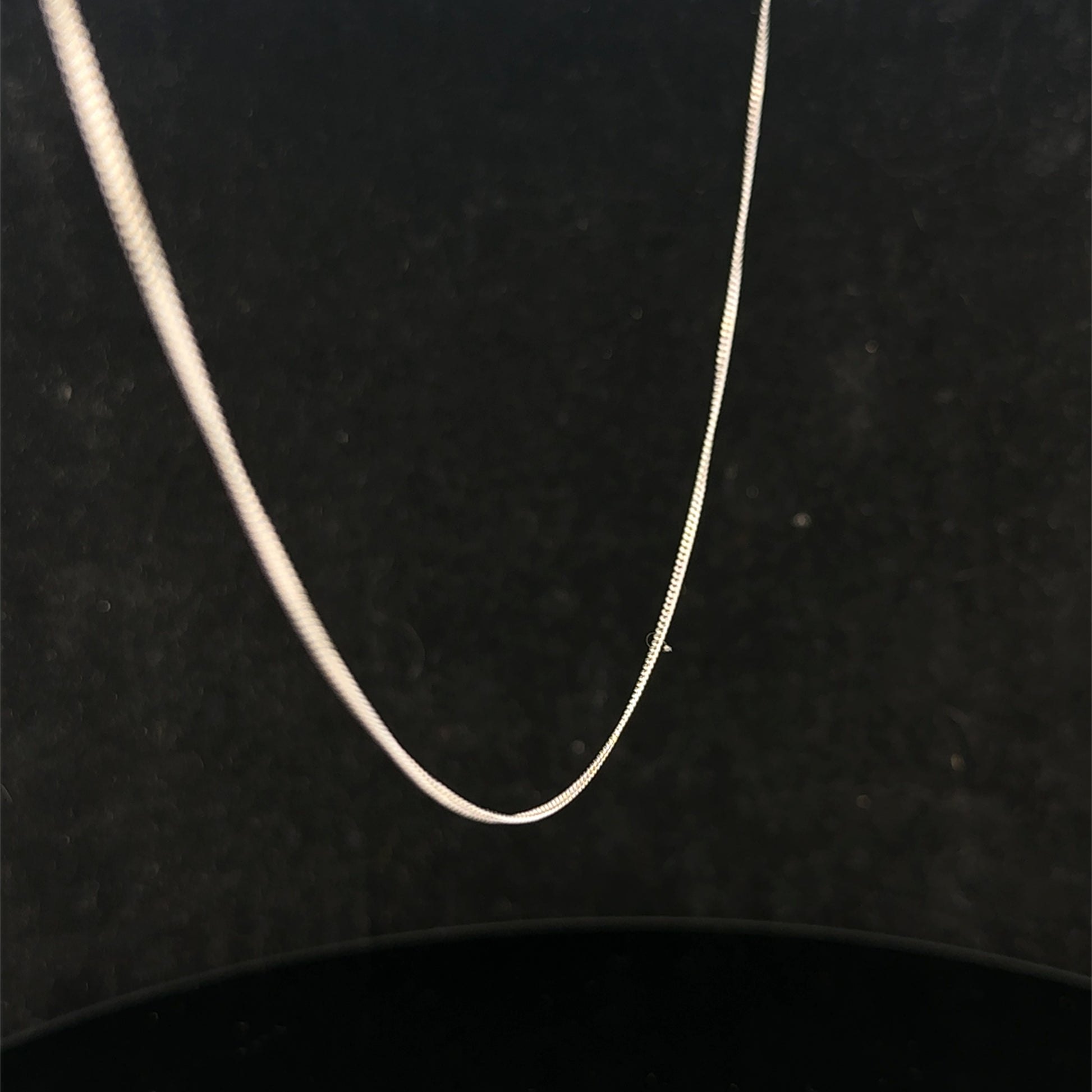 9ct white gold chain weighing 1.5g, featuring a delicate link design, from Reeves and Sons.