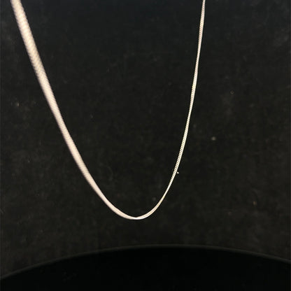 9ct white gold chain weighing 1.5g, featuring a delicate link design, from Reeves and Sons.