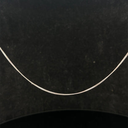 9ct white gold chain from Reeves and Sons, 1.5g, with a delicate link design, shown laying flat on a neutral background.