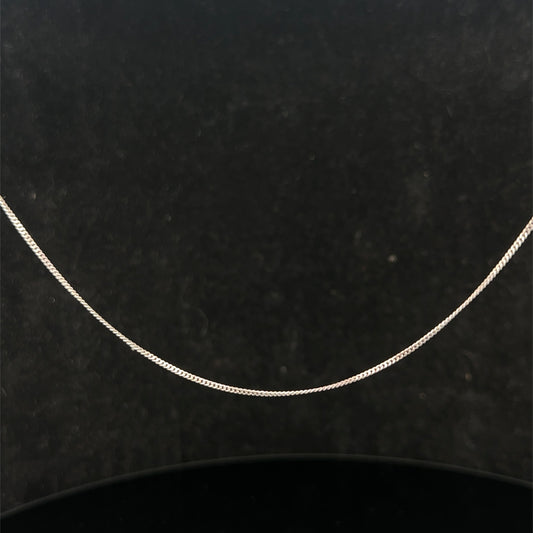 9ct white gold chain from Reeves and Sons, 1.5g, with a delicate link design, shown laying flat on a neutral background.
