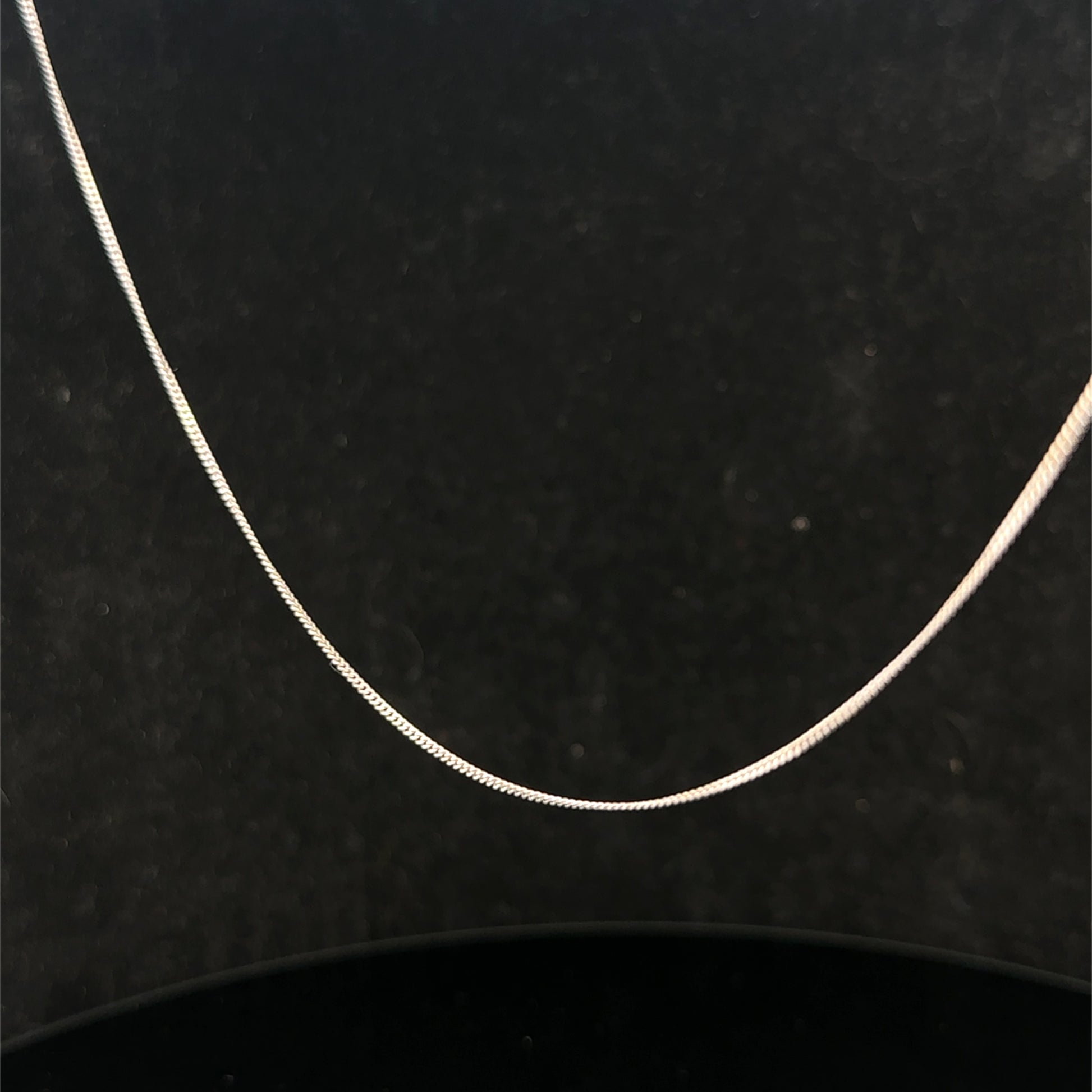 Reeves and Sons 9ct white gold chain, 1.5g, with a delicate link design, displayed against a neutral background.