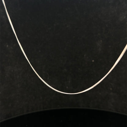 Reeves and Sons 9ct white gold chain, 1.5g, with a delicate link design, displayed against a neutral background.
