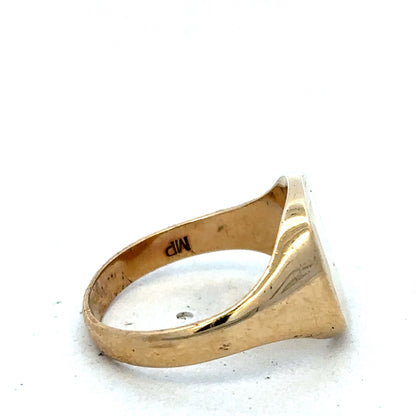9ct yellow gold signet ring in size U by Reeves and Sons, featuring a polished, classic design with a smooth band.