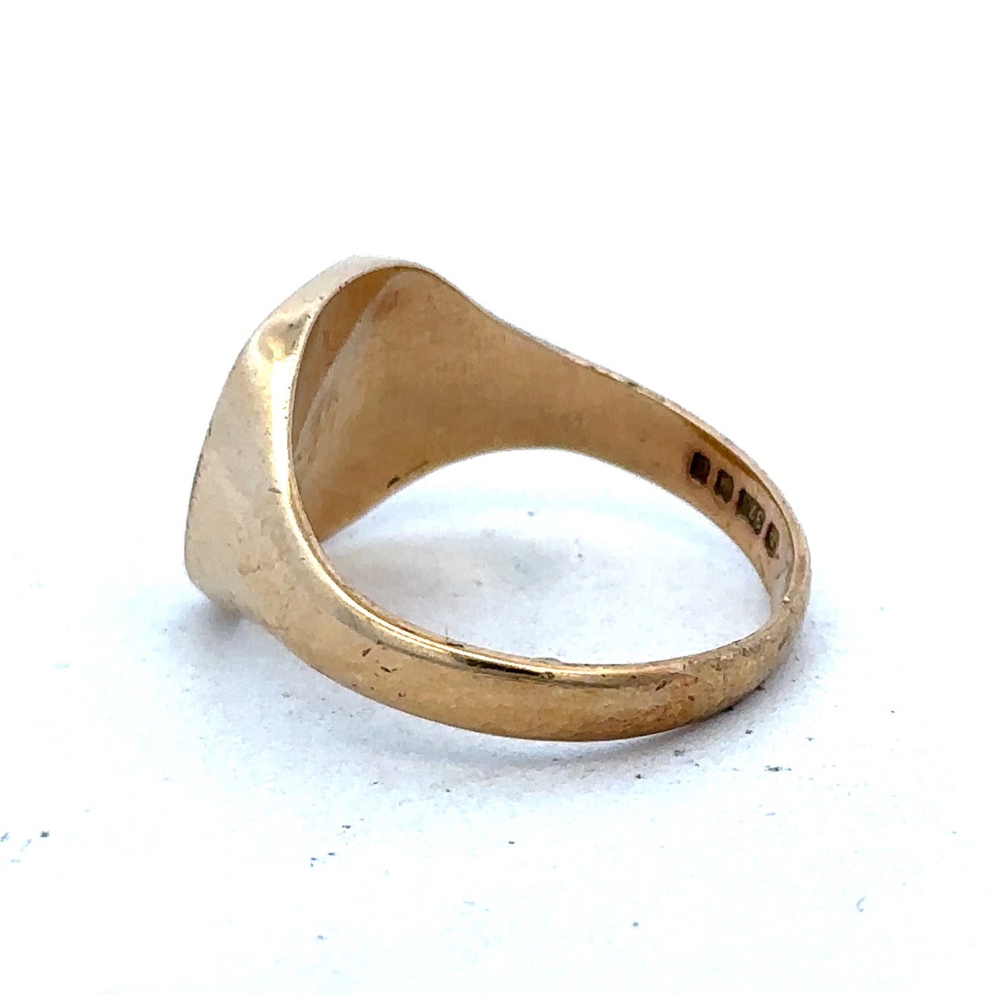 9ct yellow gold signet ring in size U with Reeves and Sons branding, shown close-up with polished finish.