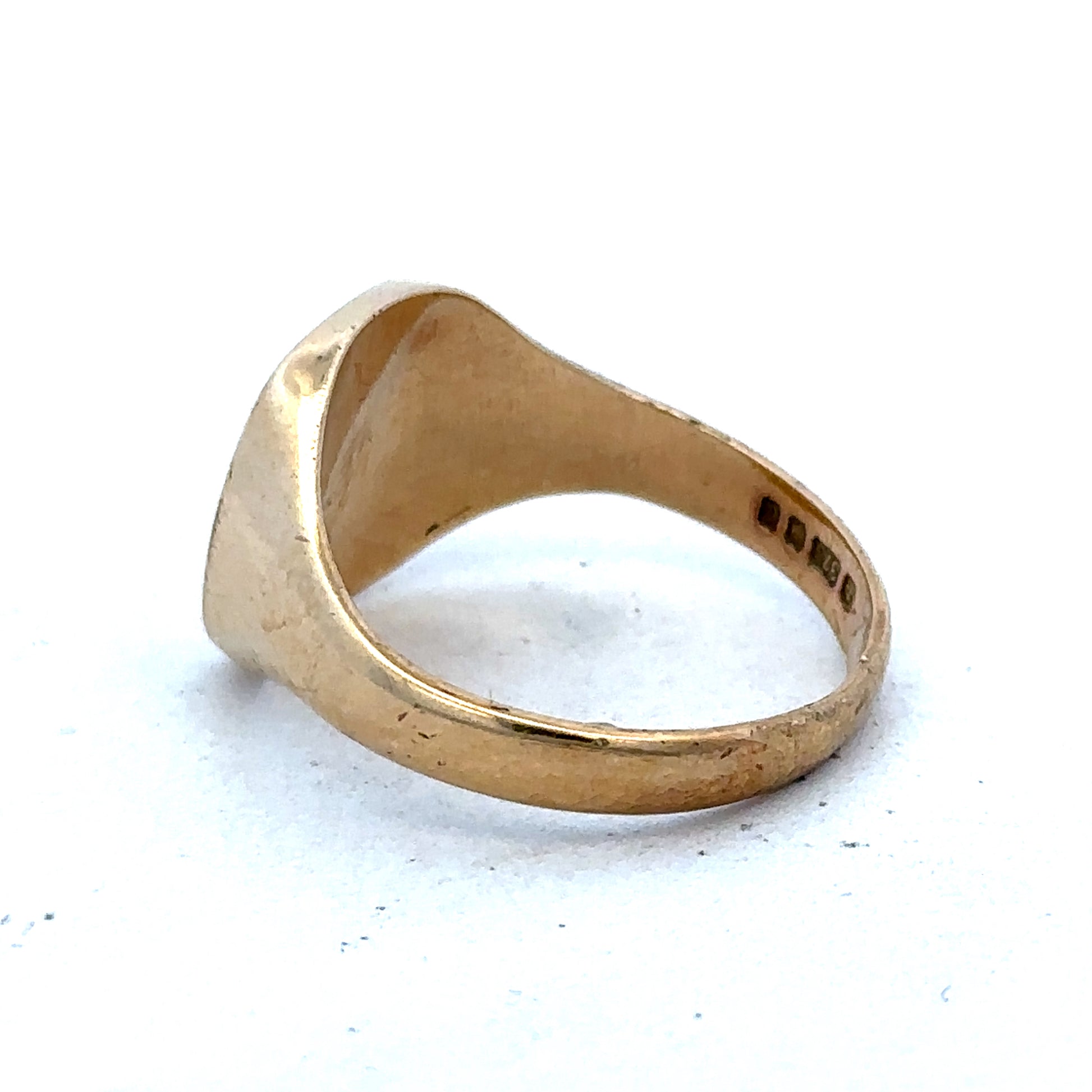 9ct yellow gold signet ring in size U with Reeves and Sons branding, shown close-up with polished finish.