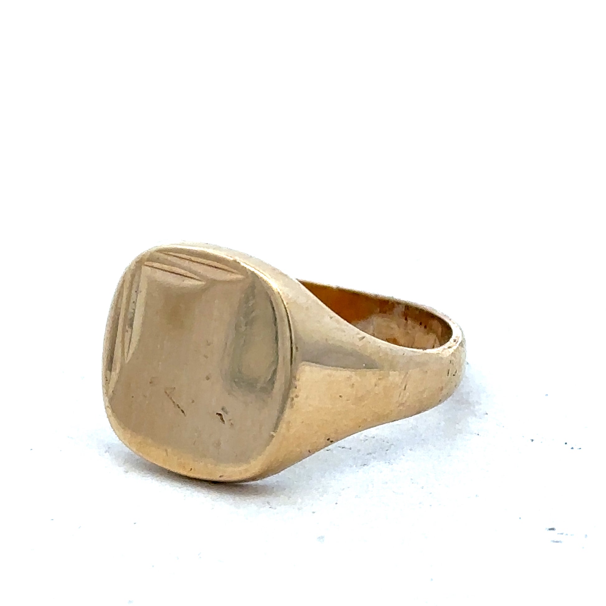 9ct yellow gold signet ring in size U with Reeves and Sons branding, featuring a polished smooth surface and classic design.