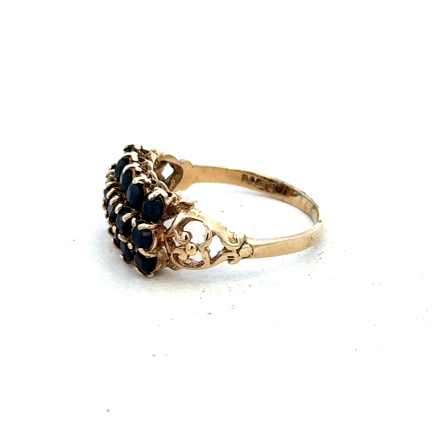 9ct yellow gold sapphire ring in size P with a central blue sapphire gemstone, featuring a polished band and detailed craftsmanship.