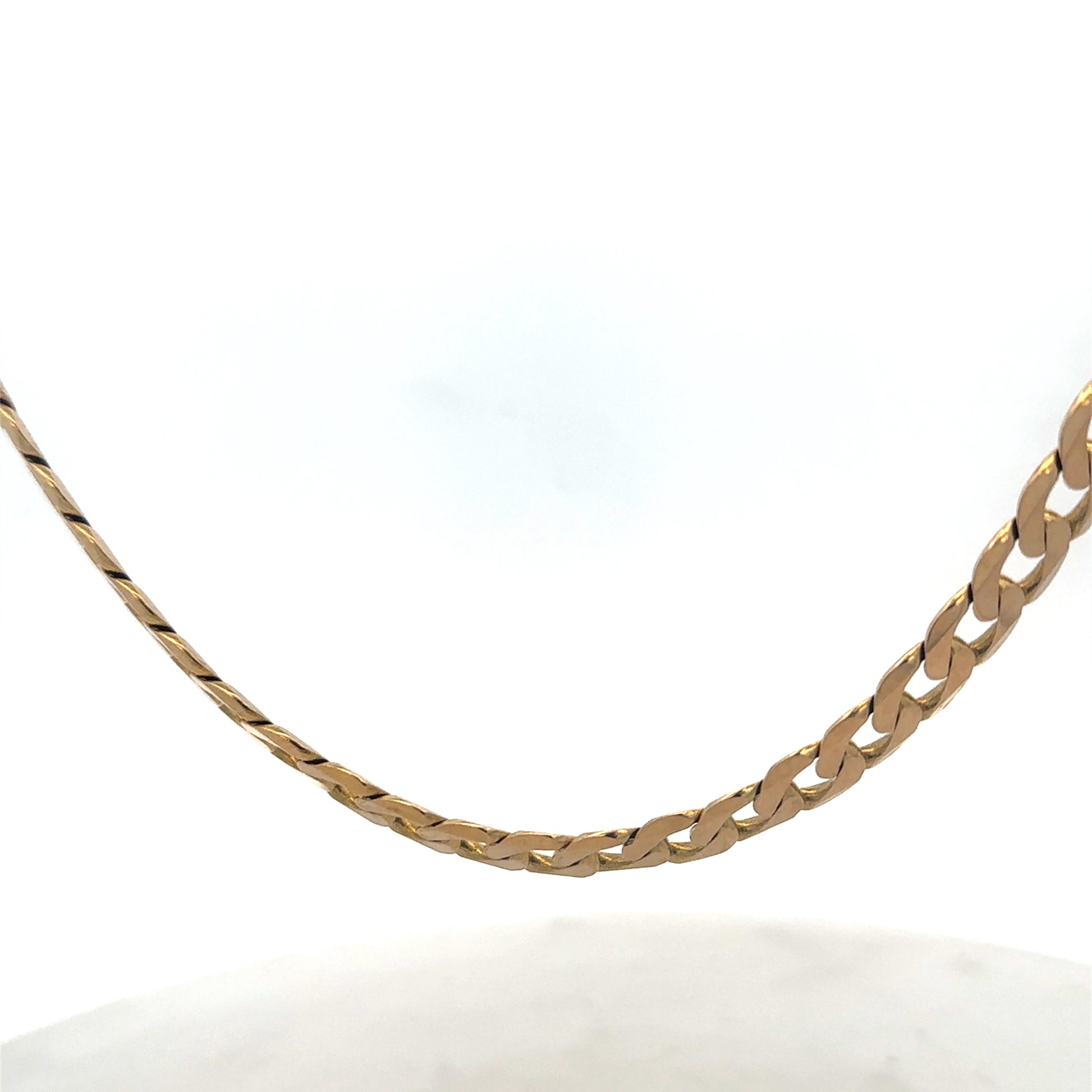 Reeves and Sons 9ct yellow gold curb chain, 47.6g, with detailed links, displayed on a neutral background.