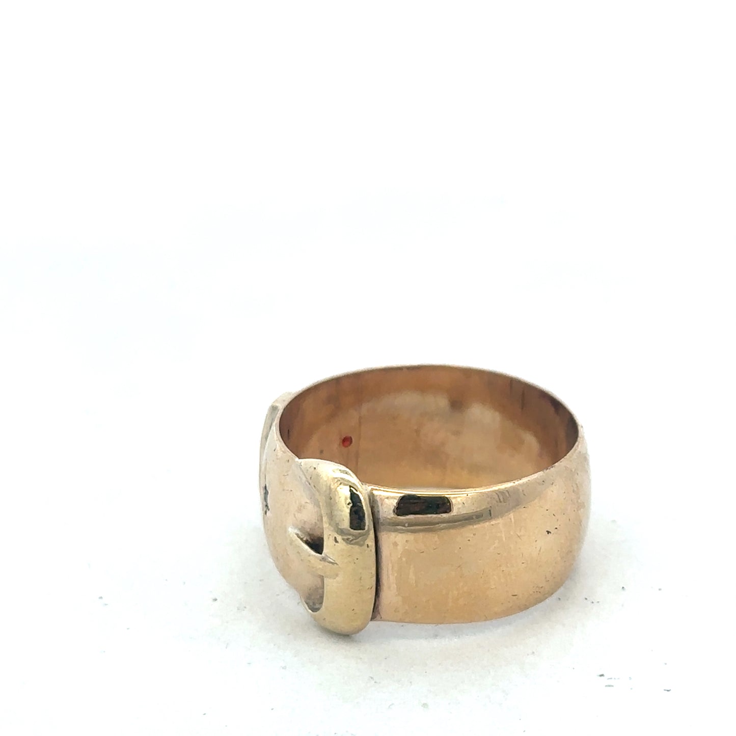 9ct yellow gold buckle ring in size Z2 with a polished finish, designed by Reeves and Sons, shown close-up.