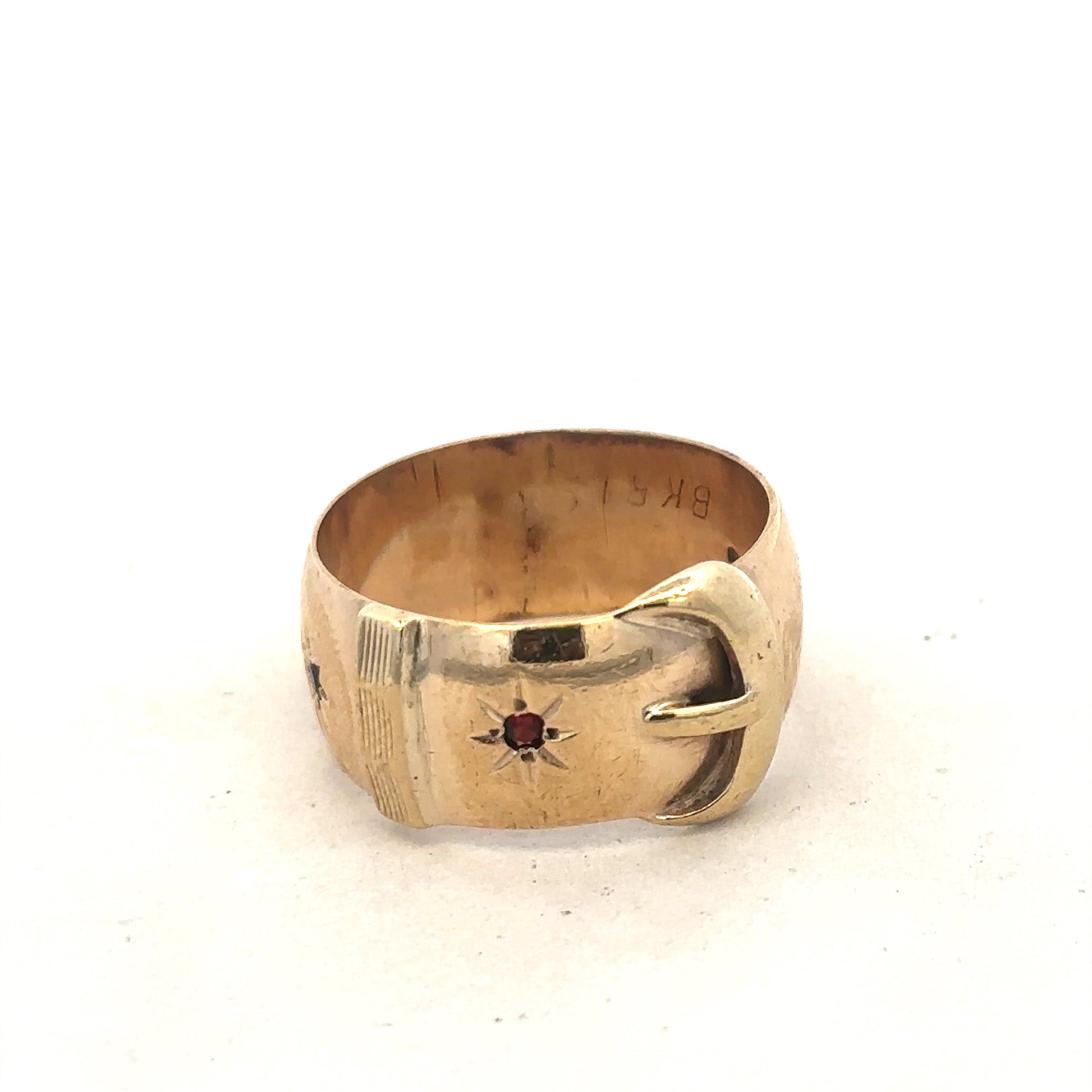 9ct yellow gold buckle ring in size Z2 by Reeves and Sons, close-up showing polished finish and detailed buckle design.