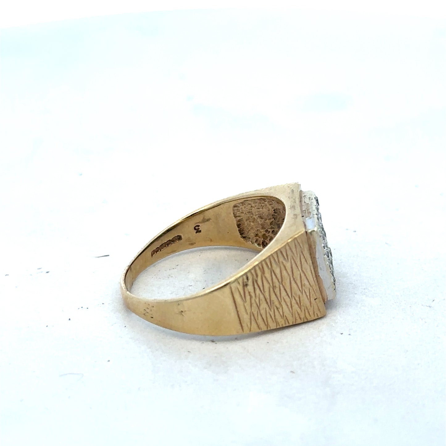 9ct yellow gold diamond signet ring in size V by Reeves and Sons, featuring a polished gold band with a diamond accent.