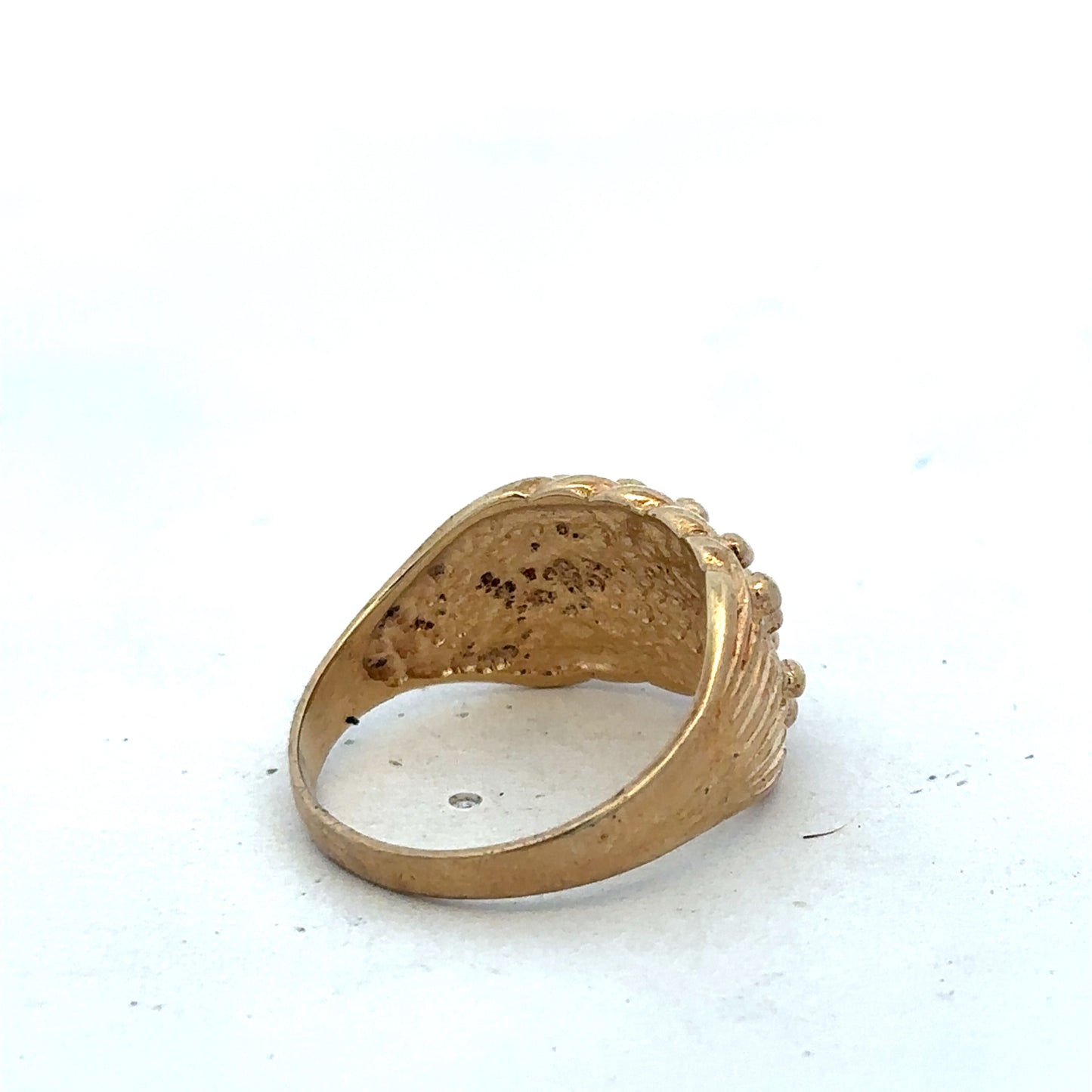 9ct yellow gold keeper ring size U by Reeves and Sons, close-up of the smooth shiny band with engraved details.