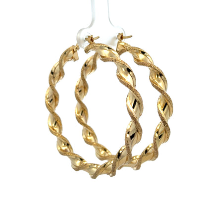9ct yellow gold hoop earrings with a polished finish, weighing 5.8g, from Reeves and Sons, shown close-up against a neutral background.