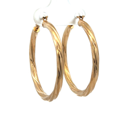 9ct yellow gold hoop earrings weighing 2.5g, featuring a classic circular design, from Reeves and Sons.