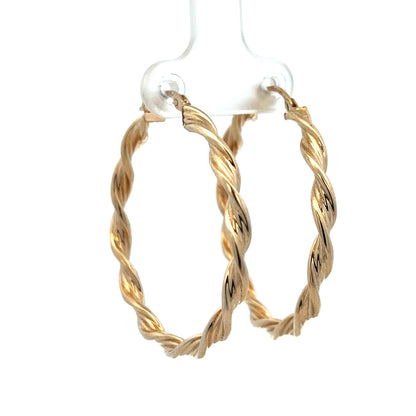 9ct yellow gold hoop earrings weighing 3g, featuring a classic round design, by Reeves and Sons, shown on a white background.