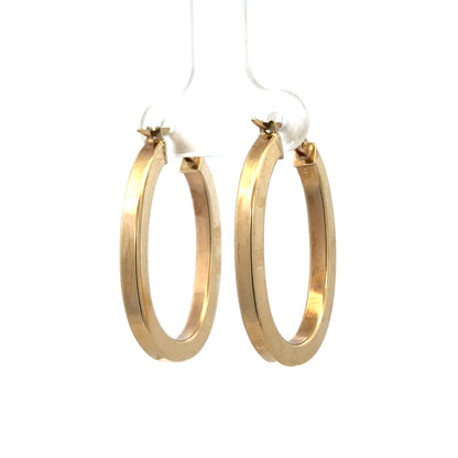 9ct yellow gold hoop earrings by Reeves and Sons, 2.1g, close-up view showing smooth circular design and polished finish.