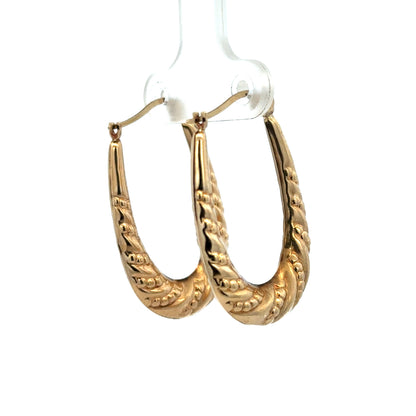9ct yellow gold hoop earrings with a 1.7g weight from Reeves and Sons, shown in a close-up image highlighting their polished finish.