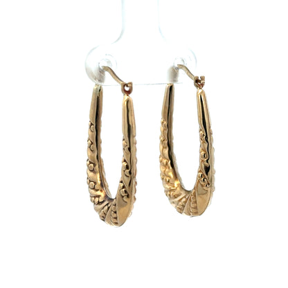 9ct yellow gold hoop earrings weighing 1.7g, stylish and lightweight jewelry by Reeves and Sons, shown in close-up image.