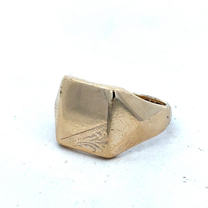 9ct yellow gold signet ring size P1/2 by Reeves and Sons, close-up of polished gold band with engraved face.