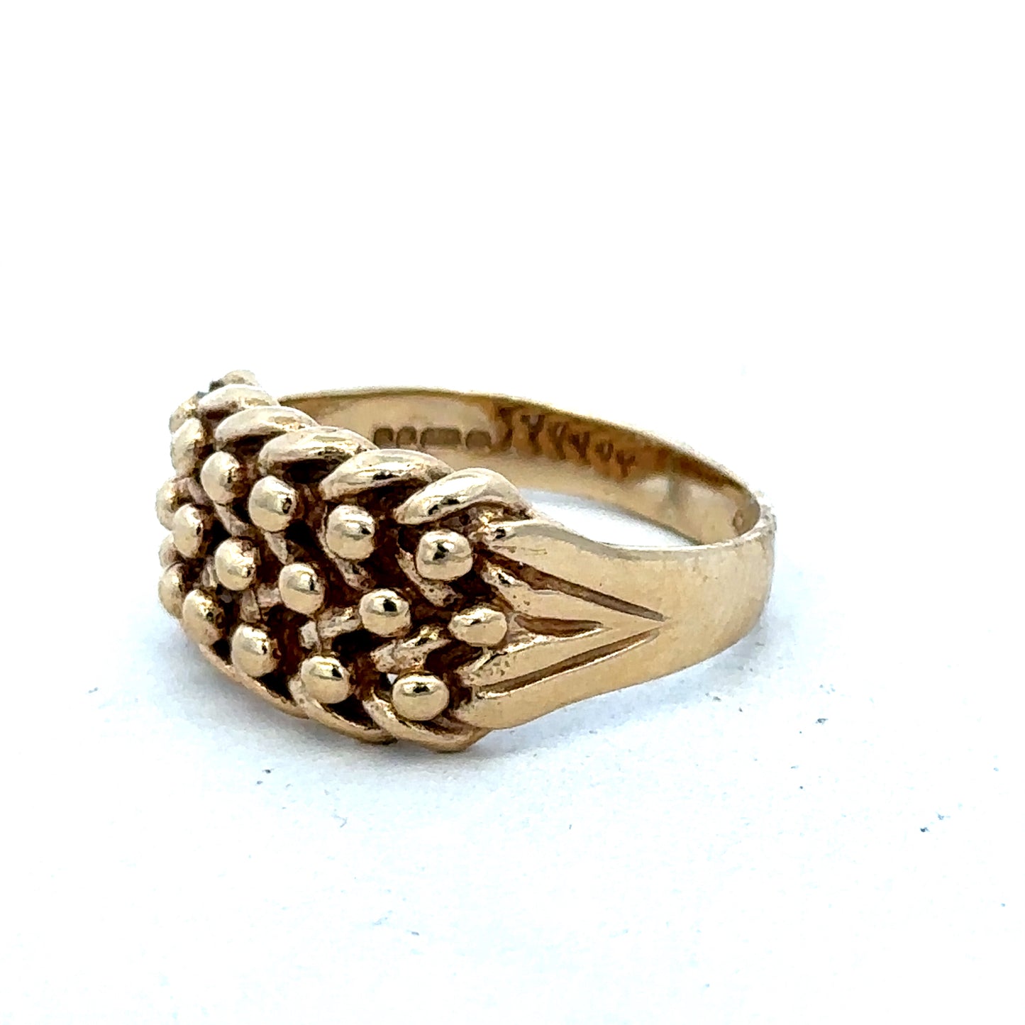9ct yellow gold keeper ring size T1/2 with a smooth band, crafted by Reeves and Sons, shown in close-up detail.