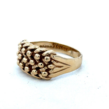 9ct yellow gold keeper ring size T1/2 with a smooth band, crafted by Reeves and Sons, shown in close-up detail.